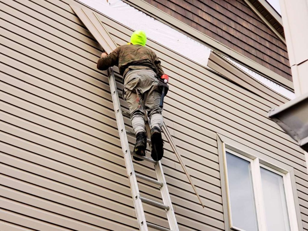 a man installing a siding